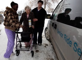 Dora Pratt, center, is helped to a waiting van as she is evacuated with all residents at the Elim Rehab & Care Center on March 26, 2009 in Fargo, N.D. (Carolyn Kaster/AP Photos)