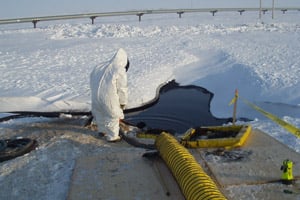 Workers respond on March 3, 2006 to the largest oil spill on Alaska's North Slope after 200,000 gallons of oil leaked from a hole in a pipeline in Prudhoe Bay. (BPXA)