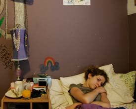 Sara Dill, then 17, lays in her bed. Her father, Wade, took the</p><p>contractor job in Iraq to start a college fund for her. (Francine Orr/</p><p>Los Angeles Times/July 16, 2007)