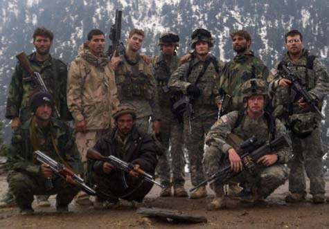 Farshad Yewazi (standing, far left in light camo), 23, was wounded during an ambush while serving as a translator for the U.S. Army in Afghanistan. His insurance company failed to provide him medical benefits.