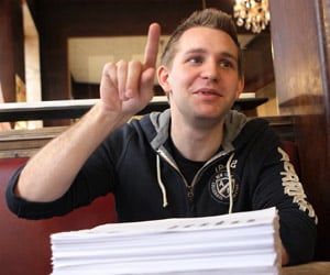 Austrian law student Max Schrems speaks with the 1,222 pages of his Facebook data in front of him. (Dieter Nagl/AFP/Getty Images)