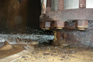 Water shoots out of a rusty pipe at the Byron nuclear plant. (Photo courtesy of the NRC)