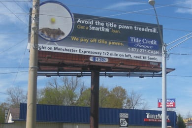 A billboard for Title Credit Finance above a TitleMax storefront shows a picture of a hamster on a wheel and urges borrowers to 'avoid the title pawn treadmill.' (Mitchell Hartman/Marketplace)