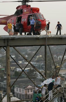 Workers move patients up the stairs from the parking garage to the helipad to be evacuated from Memorial Medical Center in New Orleans on Sept. 1, 2005. (Brad Loper/Dallas Morning News/Corbis)