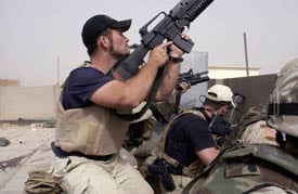Plainclothes contractors working for Blackwater USA take part in a firefight in the Iraqi city of Najaf, April 4, 2004 (AP File Photo/Gervasio Sanchez)