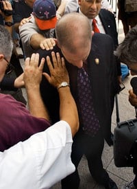 Attorney Brian Chavez-Ochoa, center, has ministers pray for him before he files a lawsuit to prevent the removal of the Ten Commandments monument from the state judicial building in Montgomery, Ala., Aug. 23, 2003. (Credit: AP Photo/Dave Martin)