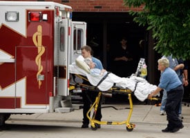 A woman is evacuated from Mercy Medical Center on June 13, 2008. (AP Photo/Jeff Roberson)