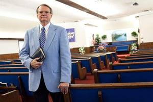 Dr. R. L. Calhoun, the Pastor of New Life Fellowship in Texas City, Texas, stands with his bible. Dr. Calhoun was one of the local religious leaders to lead the memorial service at the BP refinery after the 2005 explosion that killed 15 workers. (Lance Rosenfield/ProPublica)