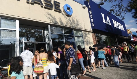 Hundreds line up outside a Chase Bank in Jackson Heights, Queens, N.Y., to take advantage of the free funds aimed at helping underprivileged children. Every child between 3 and 17 was eligible for $200. (John Taggart/New York Daily News)