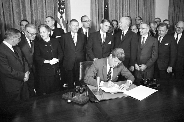 President John F. Kennedy signs the Community Mental Health Act into law on Oct. 31, 1963. (Bill Allen/AP Photo)