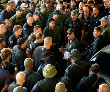 New Orleans Police Capt. Jeff Winn briefs law enforcement officers about their mission to look for people with guns in the Fischer public housing development on Sept. 7, 2005. According to police documents, Winn organized a strike force of SWAT cops and K-9 officers to investigate the water truck incident in which Keenon McCann was shot.