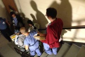 Staff at Bellevue Hospital carry a baby down a stairwell during the hospital's evacuation on Oct. 30, in New York. (Sheri Fink)