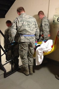 National Guard soldiers carry a patient down a stairwell at Bellevue Hospital on Nov. 1, in New York. (Sheri Fink)