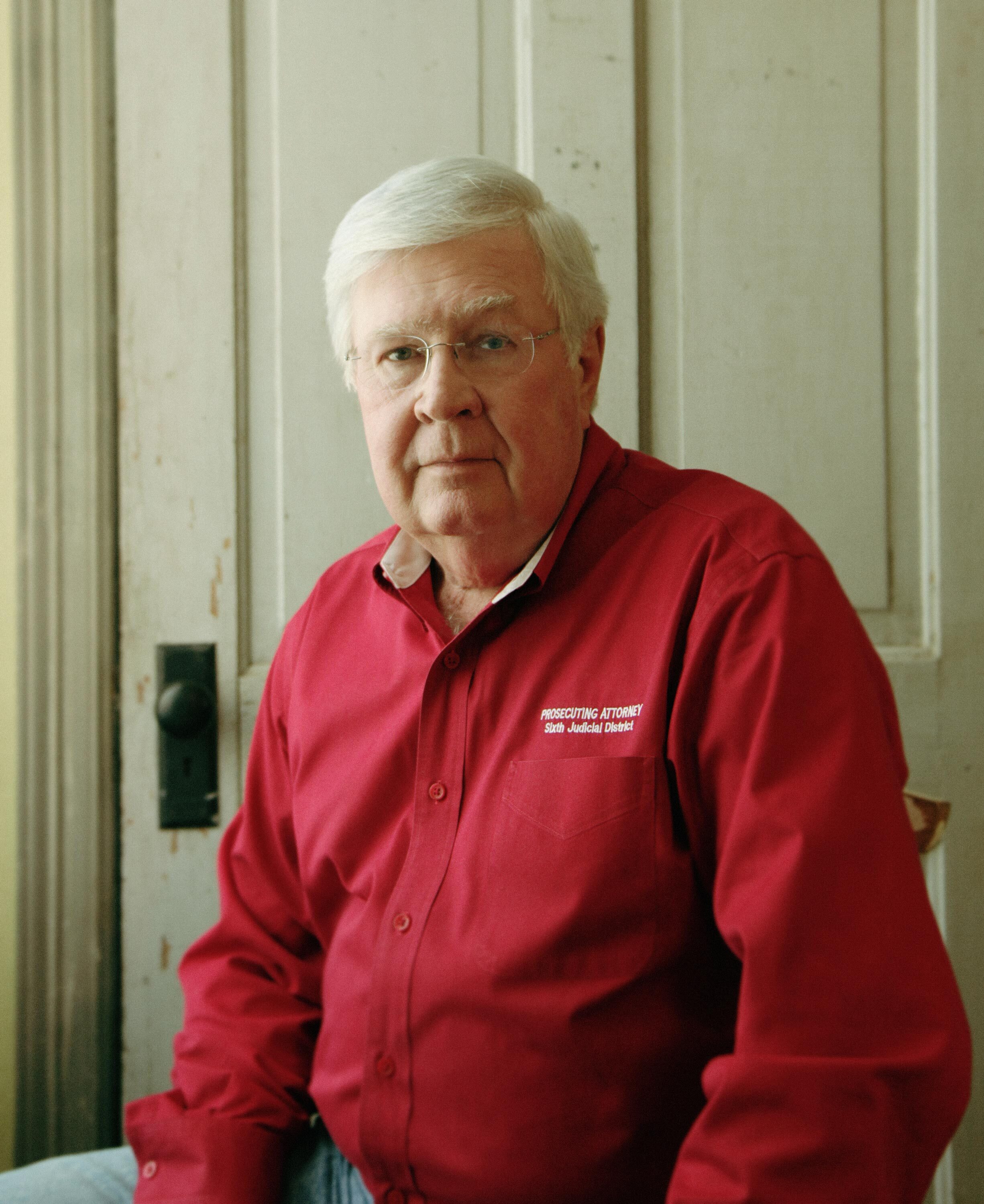 Larry Jegley (man wearing a red shirt and eyeglasses)