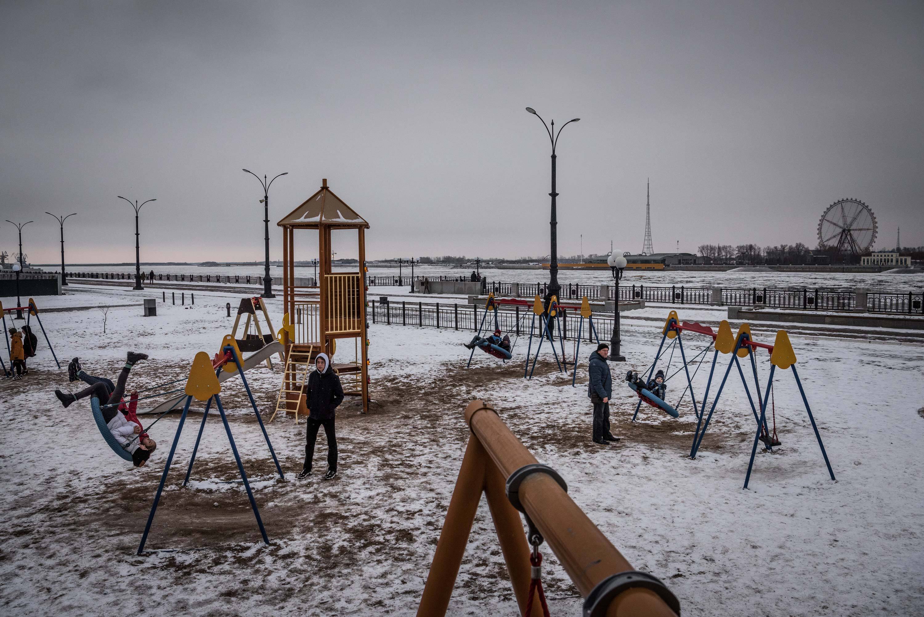 Children playing in Blagoveshchensk, Russia, with the city of Heihe, in China’s northeast, visible across the Amur River.