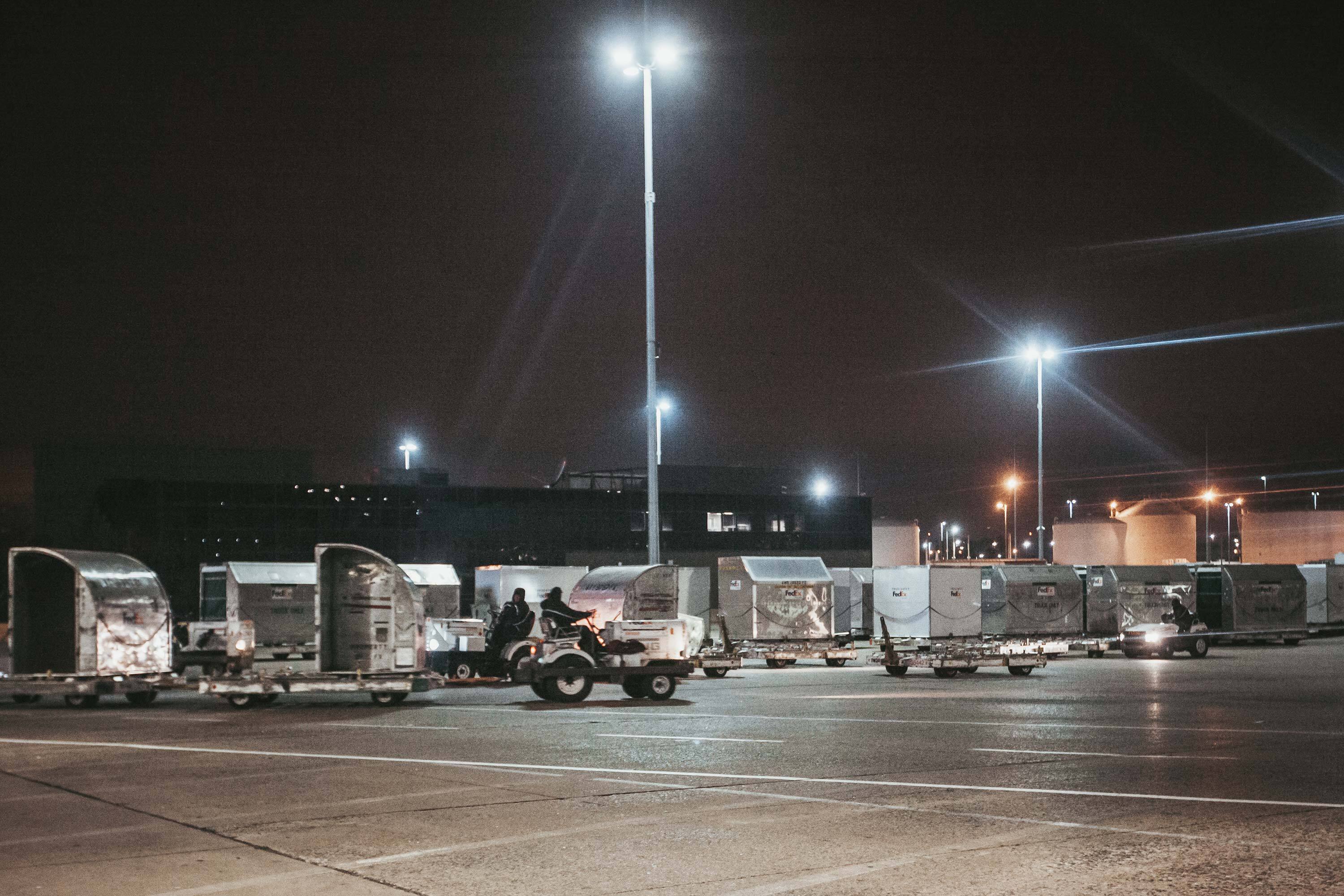 A tug pulls a dolly with cargo containers at the FedEx Express World Hub in December 2014. The containers are similar to the one involved in Young’s fatal injury.