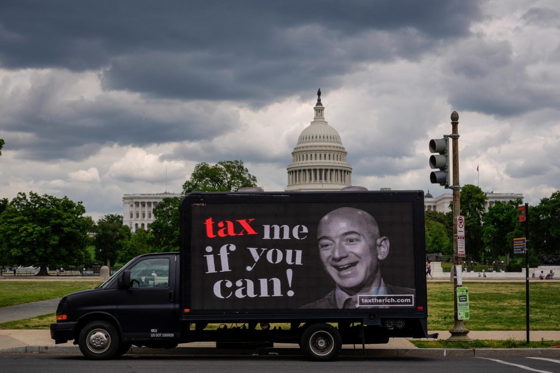 A mobile billboard with a picture of Jeff Bezos and the caption 