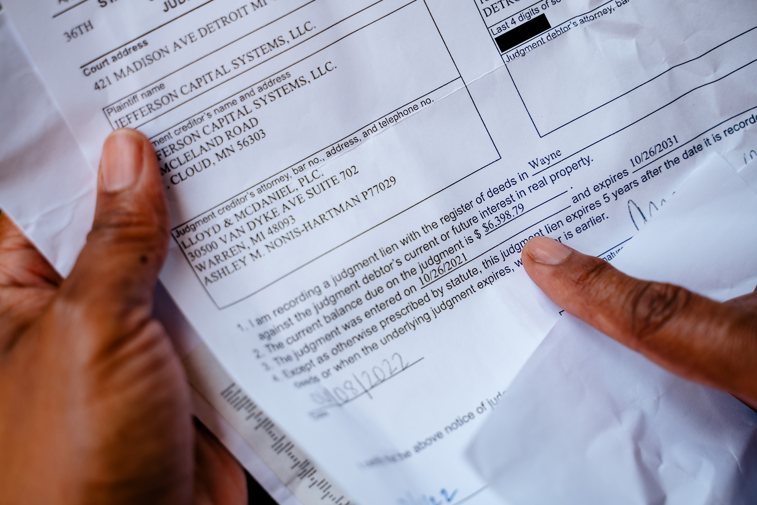 Hands hold papers that include a 