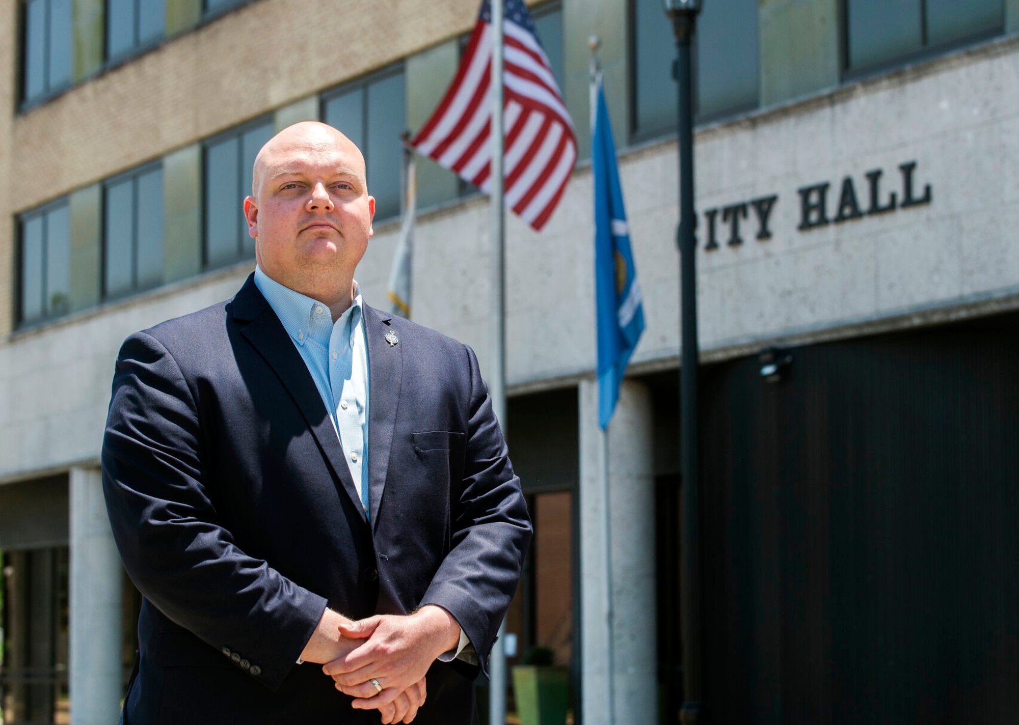 A bald man in a dark blue suit.