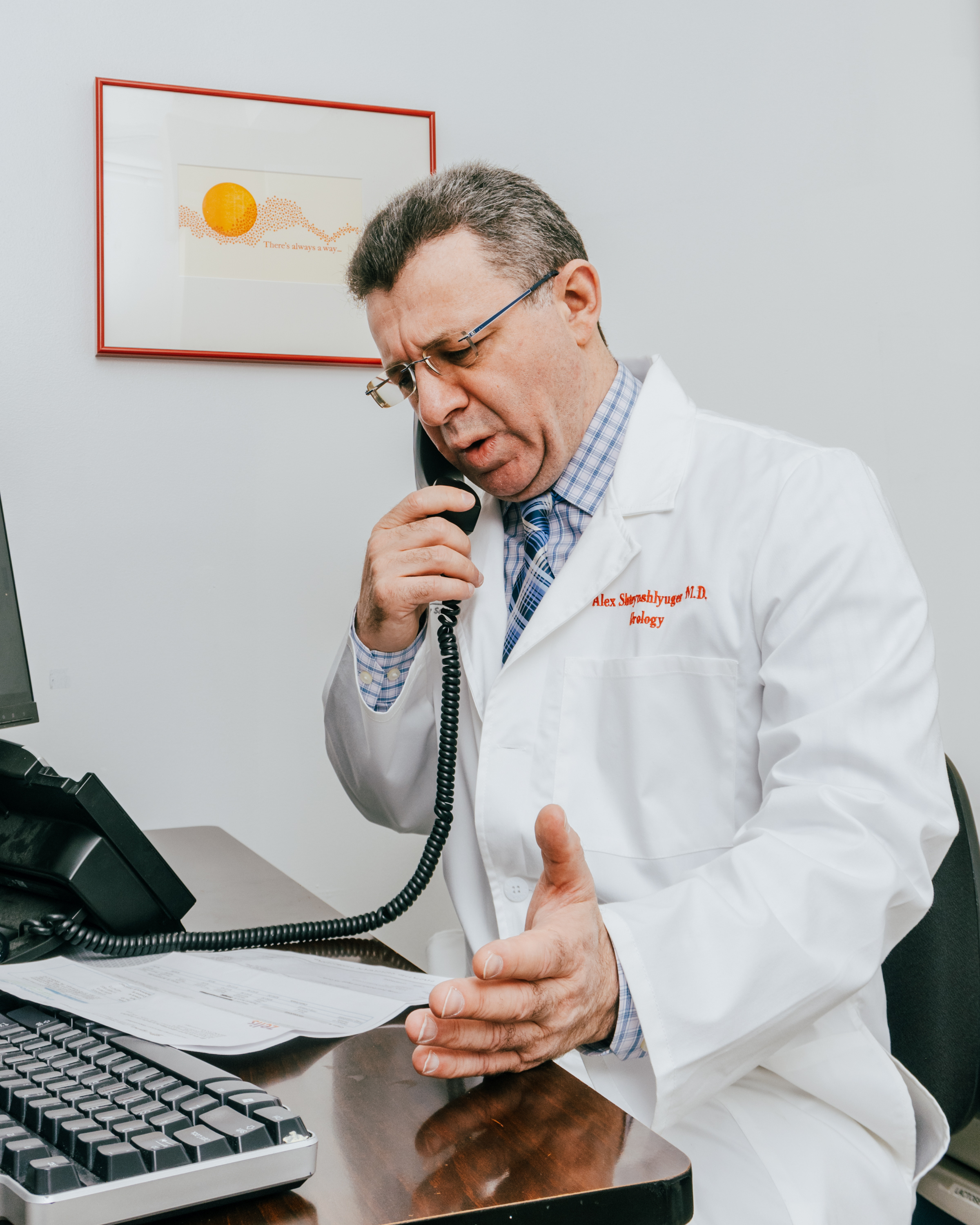 Man in lab coat on the phone.