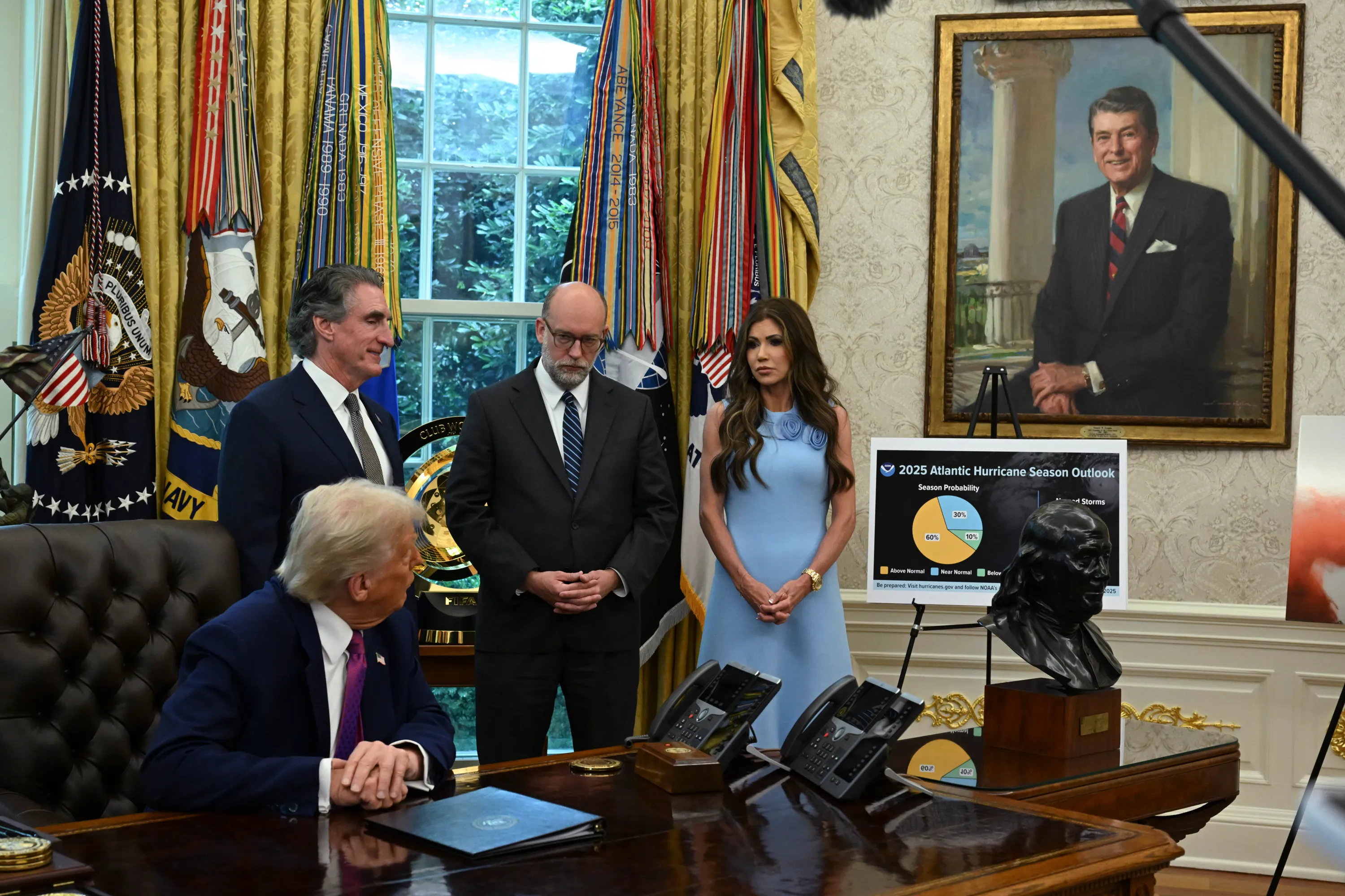 Vought in the oval office with three people, including Trump and Kristi Noem.