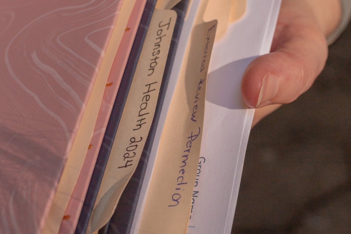 A close-up of file folders with medical records.